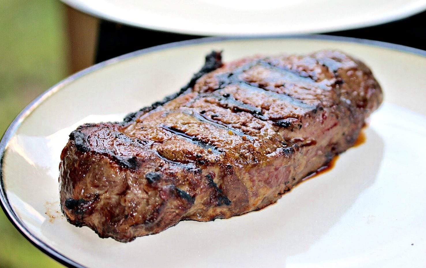 A simple combination of ingredients will bring out the best flavors in your chicken or steak, and tastes just like the Texas Roadhouse restaurant! A grilled steak resting on a white plate after being cooked.