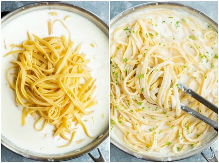 A skillet with Fettuccine Alfredo being added to it and mixed into the sauce.