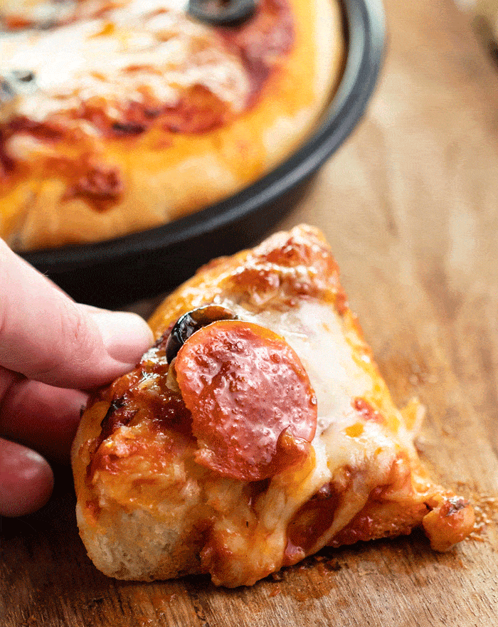 Close up shot of a pepperoni pizza slice from pizza hut personal pan pizza.