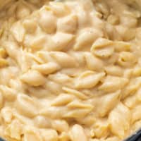 A pot full of creamy White Cheddar Shells and cheese for Panera Mac and Cheese recipe.
