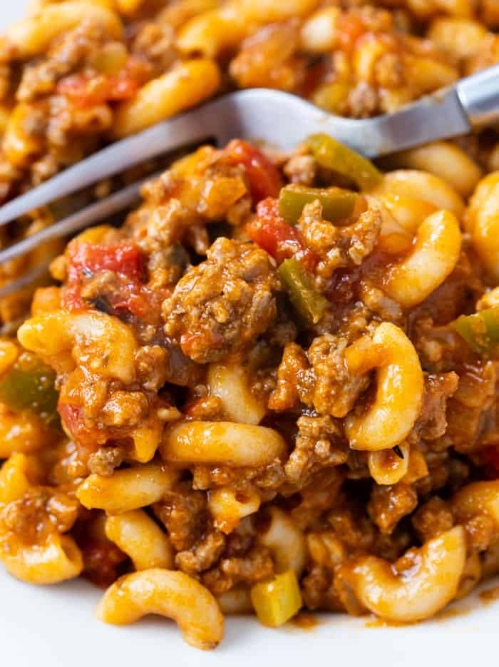 A plate of American Chop Suey with a fork behind it.