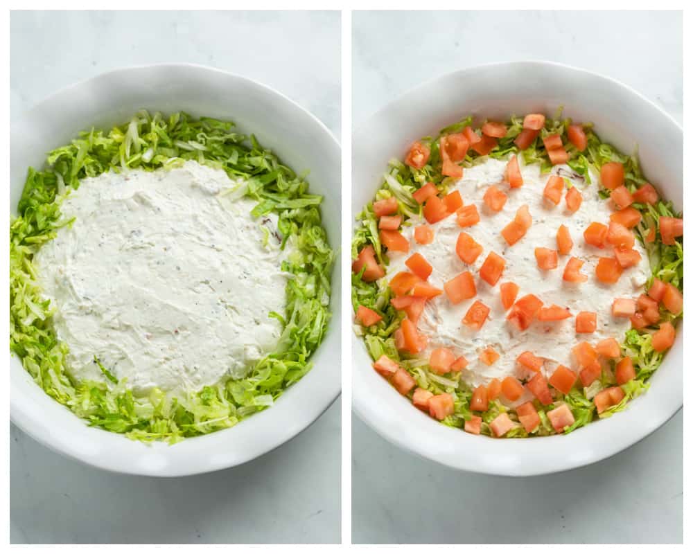 A white pie pan with BLT dip with shredded lettuce and diced tomatoes being added on top.