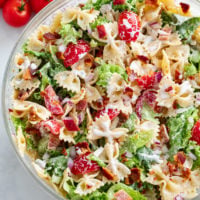 BLT Pasta Salad in a glass bowl with bacon, Lettuce, Tomatoes, and Ranch dressing.