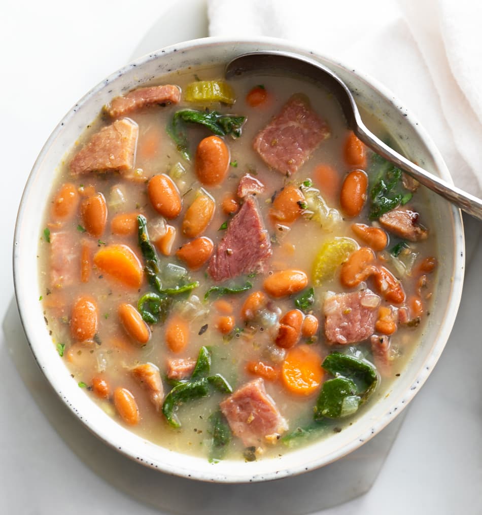 Ham Soup in a white bowl with a spoon.