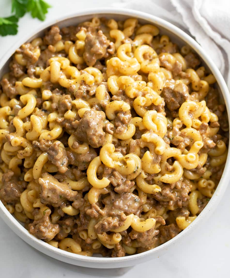 A white bowl of Hamburger Helper in a cheeseburger sauce.