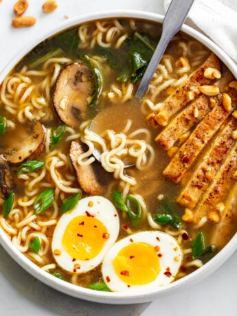 Homemade Ramen in a soup bowl with chicken, mushrooms, Bok Choy, and soft boiled eggs.