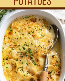 A labeled image of Au Gratin Potatoes in a baking dish with thyme on top.