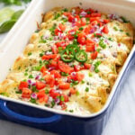White Chicken Enchiladas with a creamy white sauce, cheese, and colorful toppings.