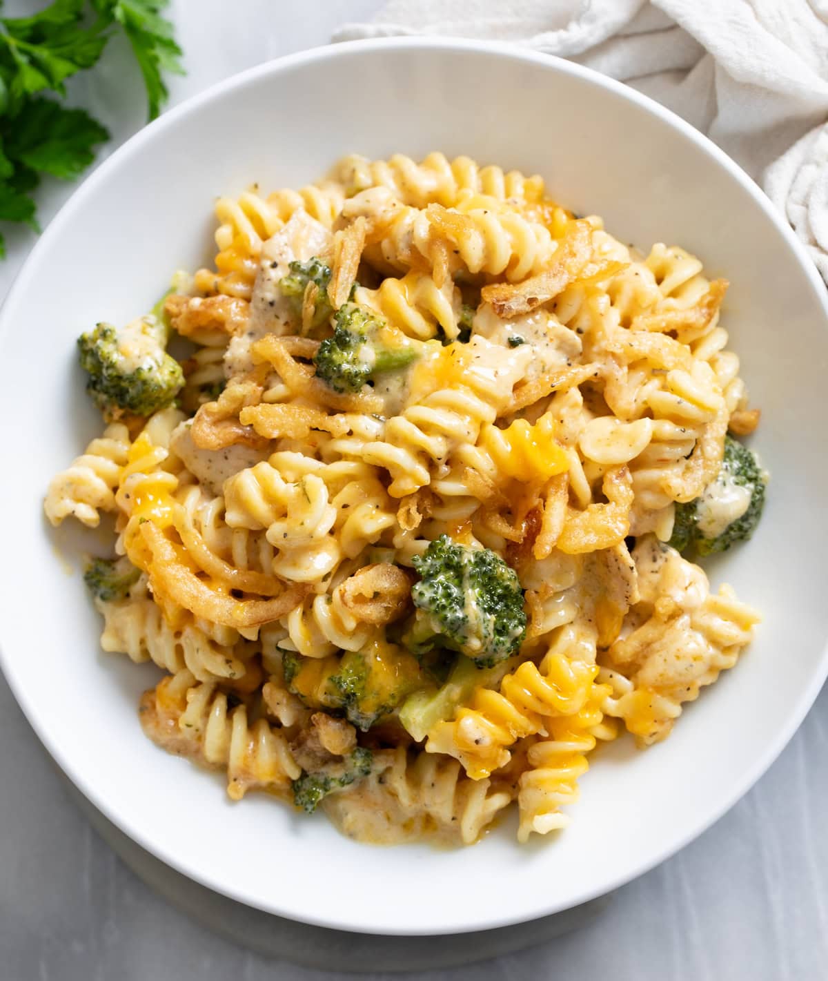 A white bowl filled with a Chicken and Broccoli Pasta Bake.