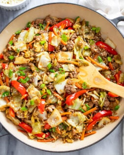 Cabbage Stir Fry in a skillet with vegetables, ground beef and pork, and a homemade sauce.