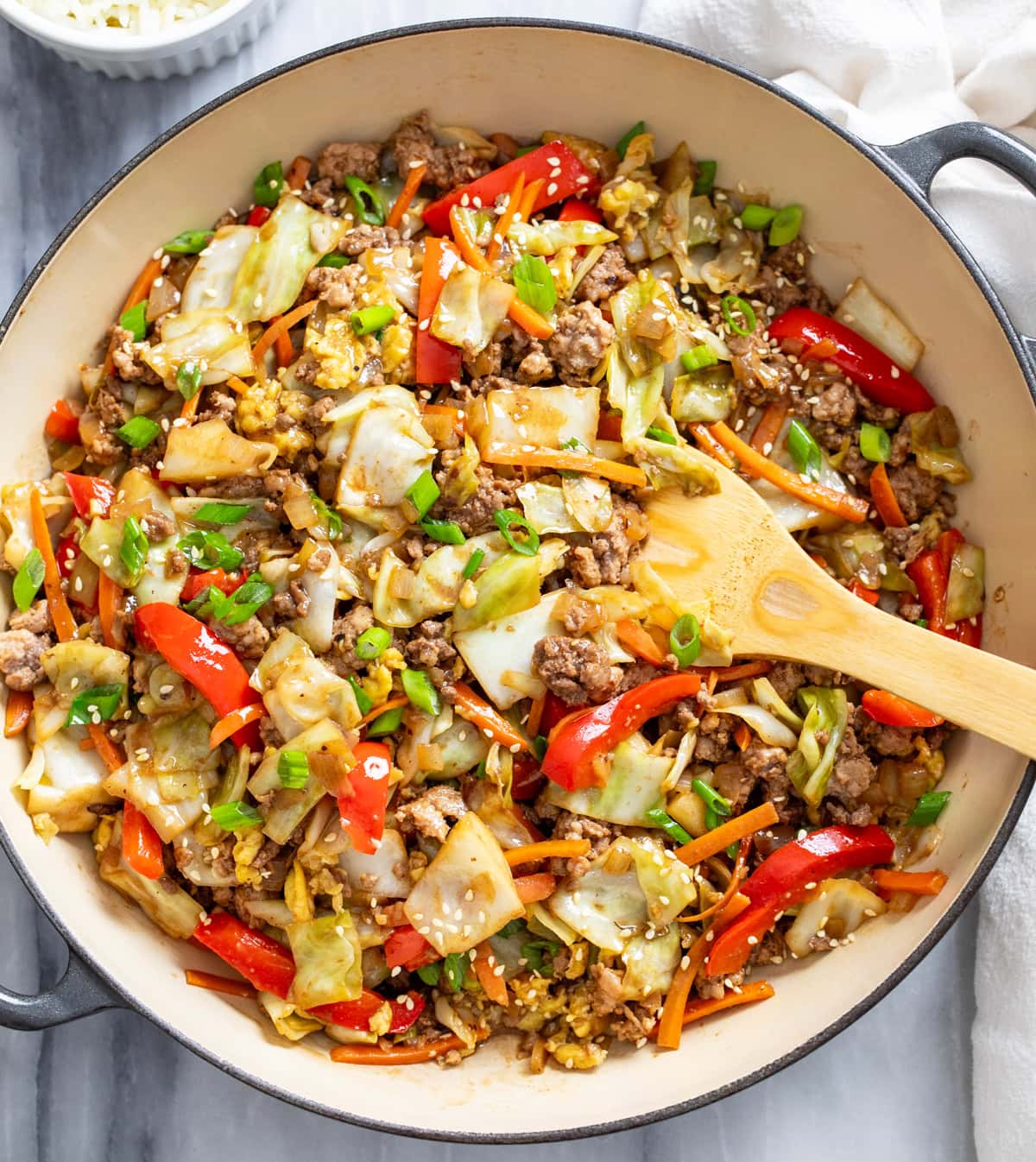 Cabbage Stir Fry in a skillet with vegetables, ground beef and pork, and a homemade sauce.